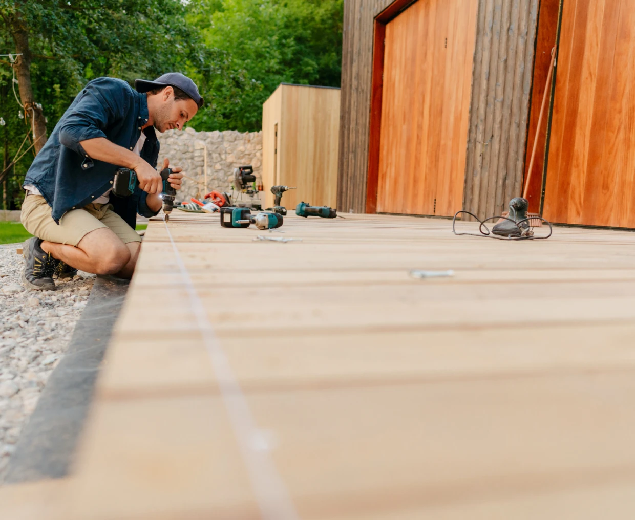 Man working on outdoor wooden deck construction